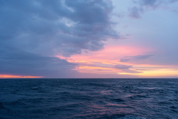 Naklejka na ściany i meble Colorful sunrise on the Drake Passage in the ocean