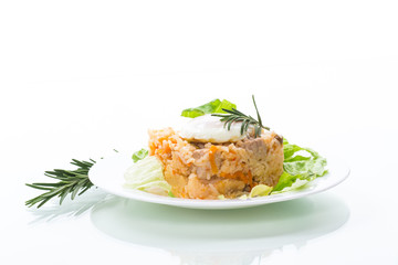 boiled rice with vegetables and fried egg with salad leaves in a plate