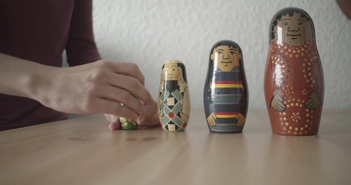  Girl playing with Matrioshka (Russian dolls. Dolls of different races, multiculturalism