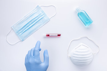 Material for the prevention of coronavirus, latex gloves, masks, hand sanitizing gel and test tube with blood sample. covid-19 and pandemic global concept .