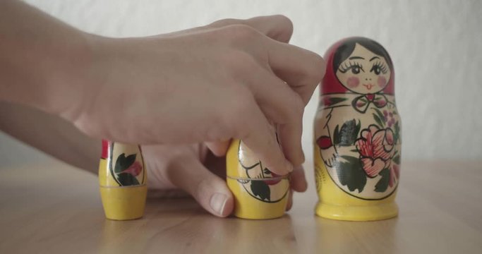 Girl playing with Matrioshka (Russian traditional dolls)