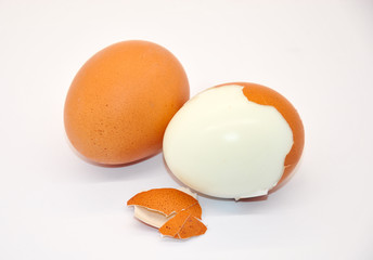  two chicken eggs. one peeled egg