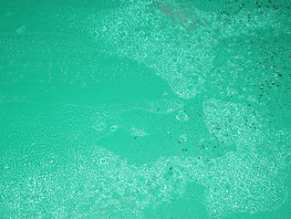 Water dispersion on a green background.