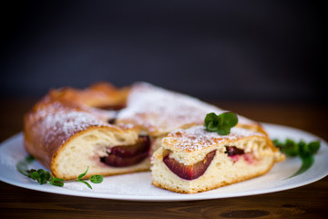sweet baked homemade plum cake with icing sugar