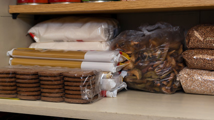 Provision shelf with buckwheat, sugar, biscuits, vermicelli and dried fruits