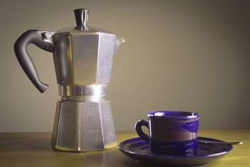 Italian coffee pot with cups of coffee