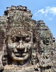 Obraz premium Ruins of Angkor, face tower of Bayon temple, closeup with blue sky, Angkor Wat, Cambodia