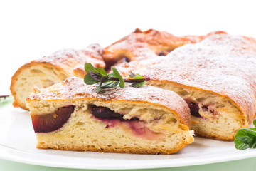 sweet baked homemade plum cake with icing sugar