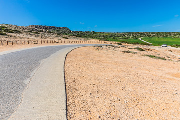 road in the middle of a green field, Ayia Napa, Cyprus. Cape Greko National Park