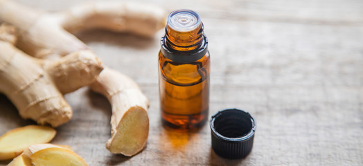 Ginger essential oil in a small bottle. Selective focus.