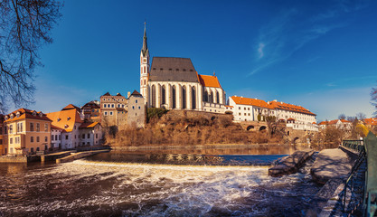 Fototapeta premium St. Vitus church in Cesky Krumlov, river Vltava in foreground, Czech republic