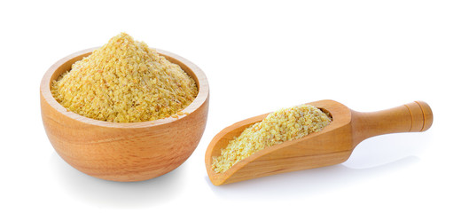 Wheat germ in wood bowl and scoop on white backgro