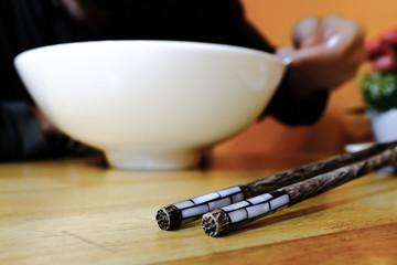 Two nice wooden chopsticks during lunch at vietnamese restaurant.