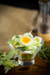 fresh spring salad with cabbage, lettuce and boiled eggs with rosemary and spices