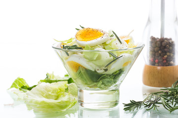 fresh spring salad with cabbage, lettuce and boiled eggs with rosemary and spices