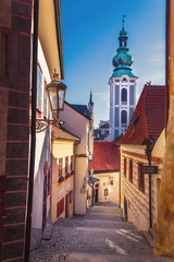 street of the old town - castle stairs, in the background the tower of the Church of St. Jost, Cesky Krumlov, Czech republic
