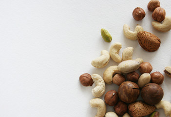 Nuts on black background, top view with copyspace. Assorted mixed nuts   on white table.
