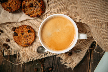 Top view coffee with cookies on the wooden table