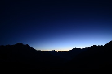 Silhouette of mountains in the Swiss mountain landscape at sunrise