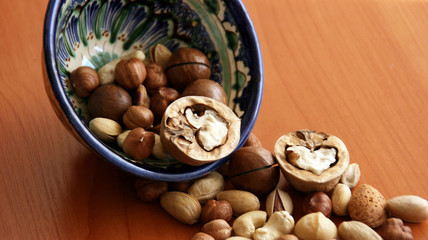 Nuts in bowl on white background, top view with copyspace.  Assorted mixed nuts  isolated on table.