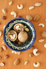 Nuts in bowl on white background, top view with copyspace.  Assorted mixed nuts  isolated on table.