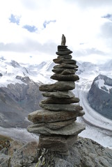 cairn in the Swiss Alps with glaciers in the background