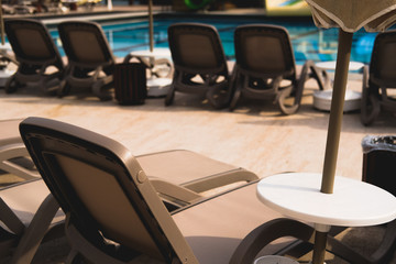 hotel territory.pool area. sun loungers grey color