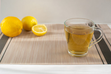 Cup of tea with on a background of lemons. Set of vitamins becouse of corona virus.