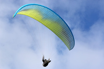 Paraglider flying wing in a blue sky	