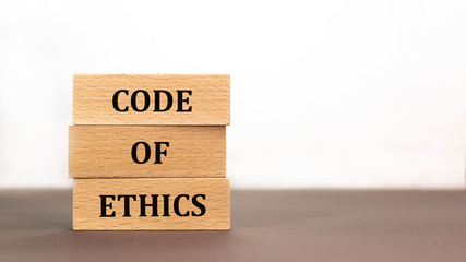 code of ethics word written on wood block on white background. Time to say text on wooden table for your desing, concept.
