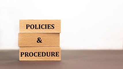 policies and procedure word written on wood block on white background. Time to say text on wooden...