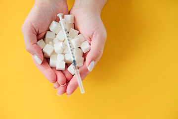 diabetes. sugar hill in the hands .syringe. the danger of sugar