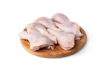 Fototapeta na wymiar Raw chicken legs on wooden board isolated on white background.