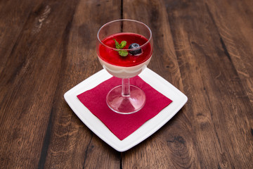 Italian dessert panna cotta on a wooden table.