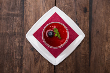 Italian dessert panna cotta on a wooden table.