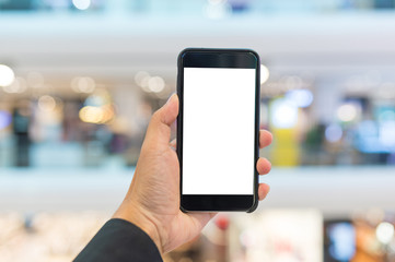 Hand hold blank smartphone on supermarket background 