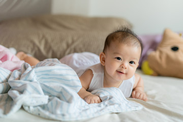 Asian baby in bed close up.