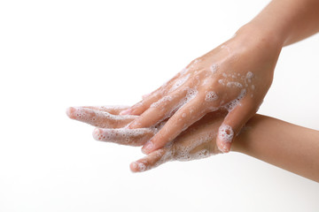 Washing hands with soap on light background. Personal hygiene concept.