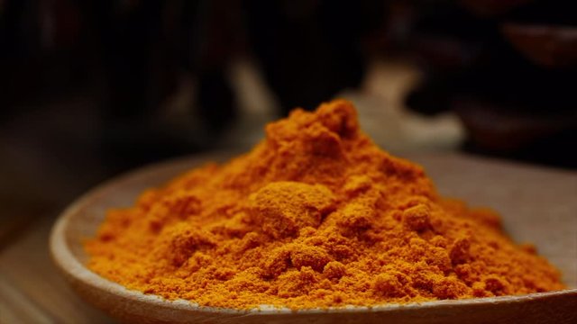 Turmeric powder in a wooden bowl