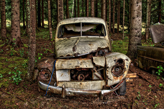 abandoned old rusty volvo pv444 car in the forest