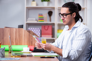 Young male designer working in the office