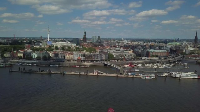 Scenic panorama over the Hamburg harbor with Landungsbruecken, the old harbor district Speicherstadt, ships and boats on river Elbe, and the TV tower with the St. Michaelis church