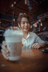 Young female student eating cake in a coffee shop