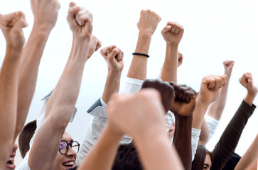 cropped image of a group of young people holding their hands up