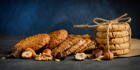 Chocolate chip and nut cookies stack with nuts background
