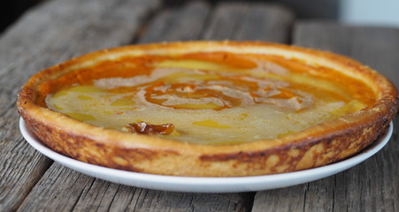 Fresh delicious homemade pumpkin pie on wooden background.