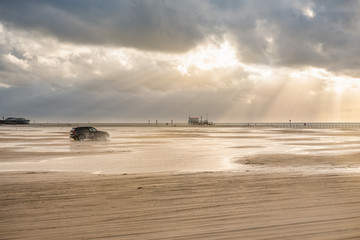 Beach of St Peter-Ording, stilt houses in background