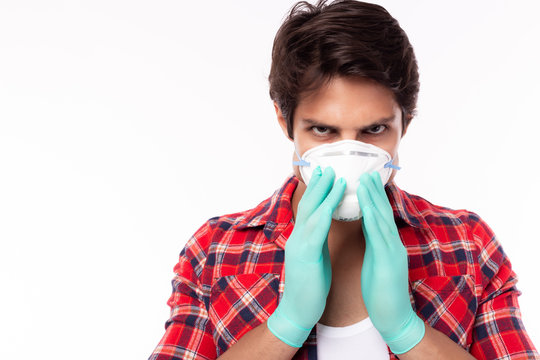 Man wear face mask, medical gloves for protecting viruses, flu, coronavirus, covid19 or pollution. Caucasian guy aware outbreak that can make him infected, sickness, allergy or dead. He gets fear