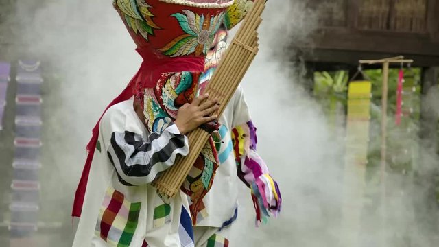 The  people in Thailand on phitakhon ghost festival holiday carnival wearing colorful custume clothes wearing hand paint mask dancing on street with happiness.  