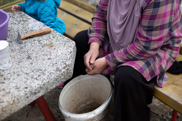 Close up photos of elderly female hands shelling walnuts. Woman holding walnut in her hands. Healthy organic food concept, harvest for good health.